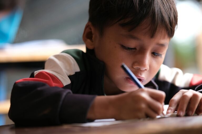 young boy concentrating on work at one of the san gabriel mission arcangel schools