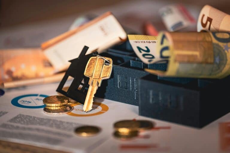 a overview of a house key next to deed paperwork
