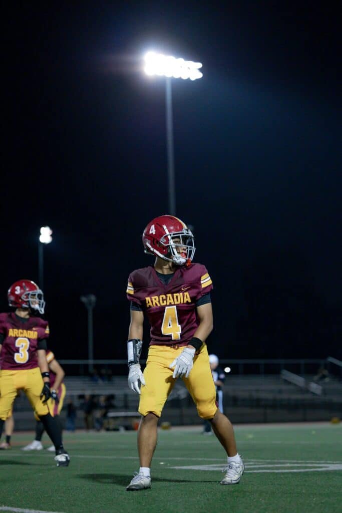 arcadia high school football player under the lights during a game